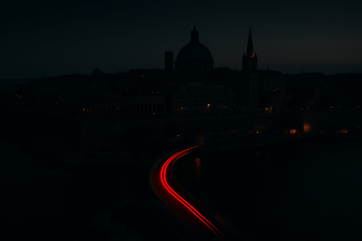 Malta at dusk with a red light trail